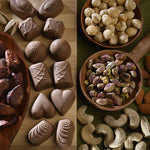 Assorted chocolates and nuts on a wooden surface